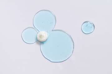 Blue liquid gel smear on white background. Beauty cosmetic smudge such as transparent lotion, facial jelly serum, cleanser, shower gel or shampoo top view.