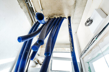 A protective corrugation for the safe installation of electrical wiring and water pipes hangs from...