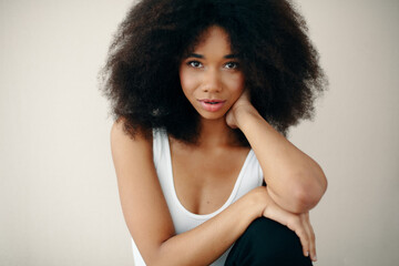 Portrait of Beautiful Young Woman Posing In Studio Over Beige Background.