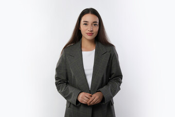 Portrait of beautiful young woman in stylish jacket on white background
