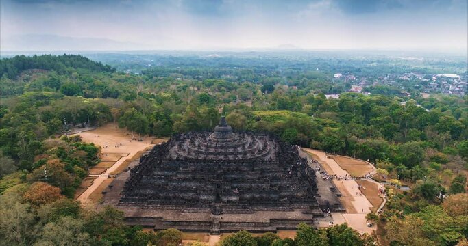 Aerial view drone hyper lapse. Borobudur temple in Java island, Indonesia. The beauty of Majestic Buddhist Temple Borobudur. Mahayana Buddhist temple architecture in Magelang in Java, Indonesia.