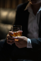 Businessman wearing a suit whiskey glass of liquor.