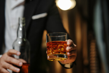 Businessman wearing a suit whiskey glass of liquor.
