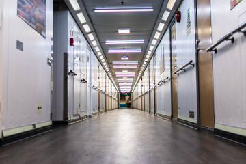 Photo of a ferry corridor with all cabin doors on the sides.