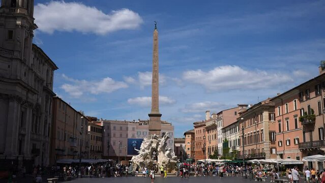Rome, Italy - 5 September 2023. Piazza Navona with 17th century Obelisco Agonale and Fountain of Four Rivers - Nile, Danube, Ganges, Rio de la Plata on sunny day, sightseeing tourists walking around.