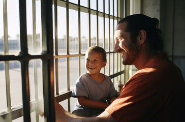 prisoners, a father and son, smile and talk in a typical prison setting - obrazy, fototapety, plakaty