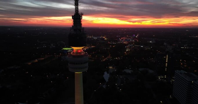 Aerial drone view of the Dortmund, Germany, tv tower Florianturm, at night. City skyline.