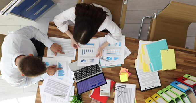 SEO boss in office scolds colleague for financial report top view. Negative commercial indicators