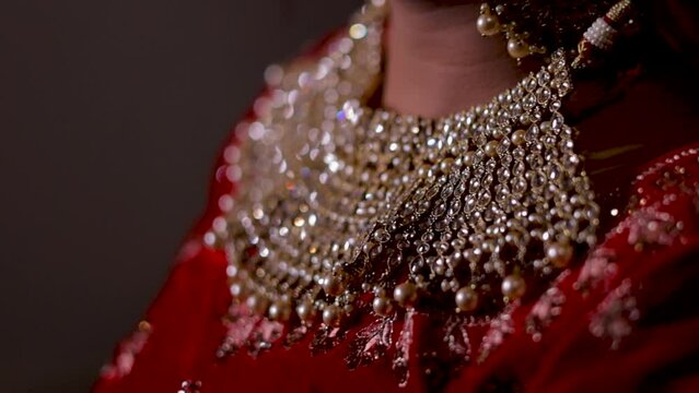 Intricate gold necklace adorned with precious gems, a symbol of beauty and tradition for Indian brides