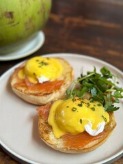 fried eggs with bacon and cheese also coconut for background