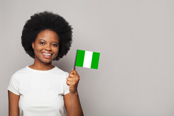 Nigerian woman holding flag of Nigeria Education, business, citizenship and patriotism concept