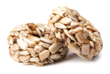 Kozinaki from sunflower seeds isolated on a white background. Round kozinaki.