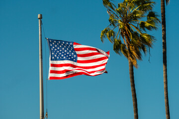 Palms and american flag, Los Angeles, California USA. American flag waving against palm trees on...
