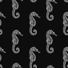 Rhythmic seamless graphic monochrome pattern composed of drawn seahorses isolated on a black background. © Юлия Ткачева