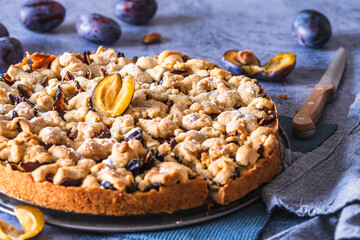 Homemade German plum cake (Zwetschgenkuchen) with yeast dough and crumbles