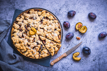 Homemade German plum cake (Zwetschgenkuchen) with yeast dough and crumbles