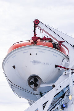 Vertical low angle photo of a crane holding the life boat