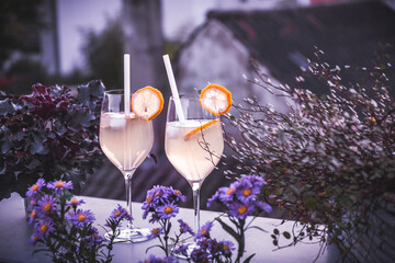 Trendy summer cold drink St Germain Spritz or Limoncello Spritz cocktail with lemon slices