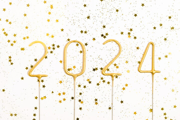 close up of number 2024 and gold glitter on white isolated background. the concept of New Year,...
