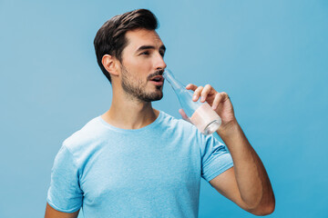 Man healthy t-shirt attractive studio drink sport smile water bottle happy lifestyle