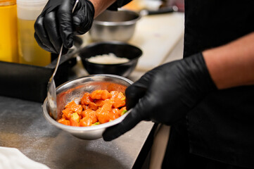 chef cooking Seviche with salmon and avocado on kitchen