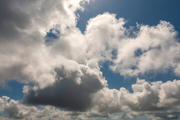 .The sky was a brilliant blue, dotted with white clouds that moved gracefully across the horizon..The wind gently blew them to and fro, seemingly without direction. .abstract sky nature background.
