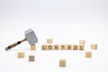 The wooden cubes with the word CONTROL and the weapon around against white background. The medieval...