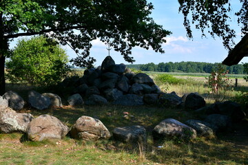A close up on a stone circle made out of massive boulders, rocks, and stones with some Celtic cross...