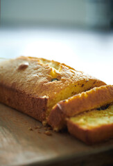 Homemade fresh butter cake with chocolate pieces on a wooden cutting board. Homemade pastry for breakfast or dessert.