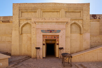 Entrance to the ancient Egyptian temple with winged scarab over the door and two cobras as well as...