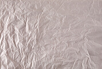 Blank crumpled brown thin packing paper background and texture, top view
