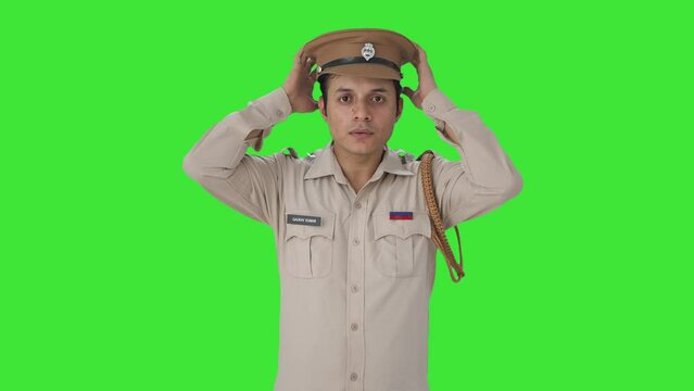 Serious Indian police officer wearing hat Green screen