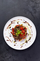 Salad with meat and tomato in a plate.