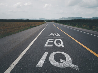 Text IQ,EQ and AQ on asphalt road