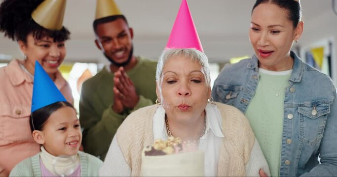 Family, blowing candles and happy birthday for grandmother, celebration and love for senior woman and cake. Smiling people, embrace and appreciation or support for elderly person, event and party hat