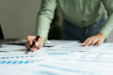 Female accountant writing data on document while analysis about accounting finance of business