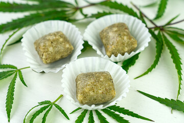 Homemade candy with hemp seeds and dates. vegan food on the blue table. narcotic product. Legalization of light drugs
