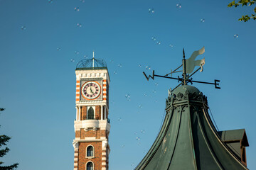 Clock Tower with Weather Vane and Floating Bubbles