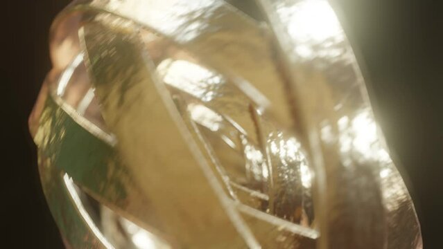 Close up shot of Golden metal circles rotating and spinning
