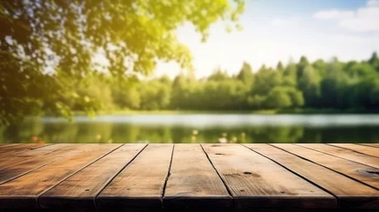Fotobehang Empty wooden table on blurred river and forest bench background.  © Farid