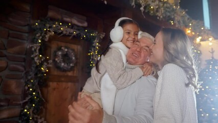 Happy holiday greeting old grandfather from lovely family, hugging child in winter festive time. New Year arrival home, dream Christmas embrace and celebrating visit