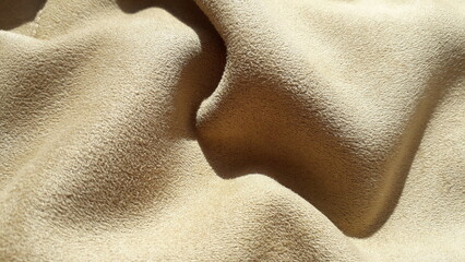Faux suede, beige polyester fabric. Texture of pile artificial fabric. Polyester.