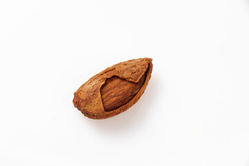 Seed of Buttered almond kernels with peel on white background. 