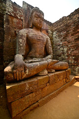 Hand carved stone statue of Buddha in meditative state at Lalitgiri Buddhist Excavation site, Odisha, India.