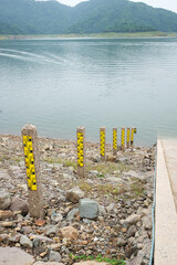 concrete poles used to measure the level of water and river in the dam of Thailand. - obrazy, fototapety, plakaty