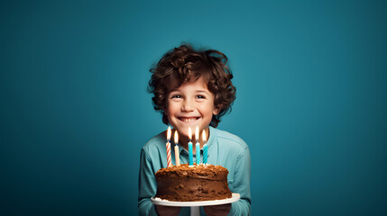 Little boy and birthday cake with candles