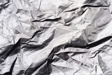 Crumpled fabric texture. Gray waterproof material wrinkled. Closeup of creased canvas background.