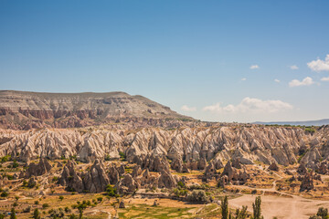 Rocky landscape in Cappadocia, Turkey. Travel in Cappadocia. Unusual semi-desert mountain ranges. Amazing Rocky summer landscape in Cappadocia Goreme