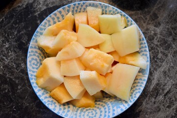 A bowl full of sliced melon