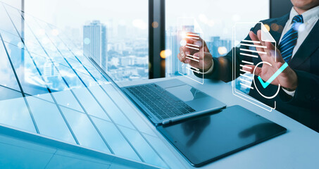 Concept of company performance monitoring: businessman utilizing laptop and tablet Online survey...